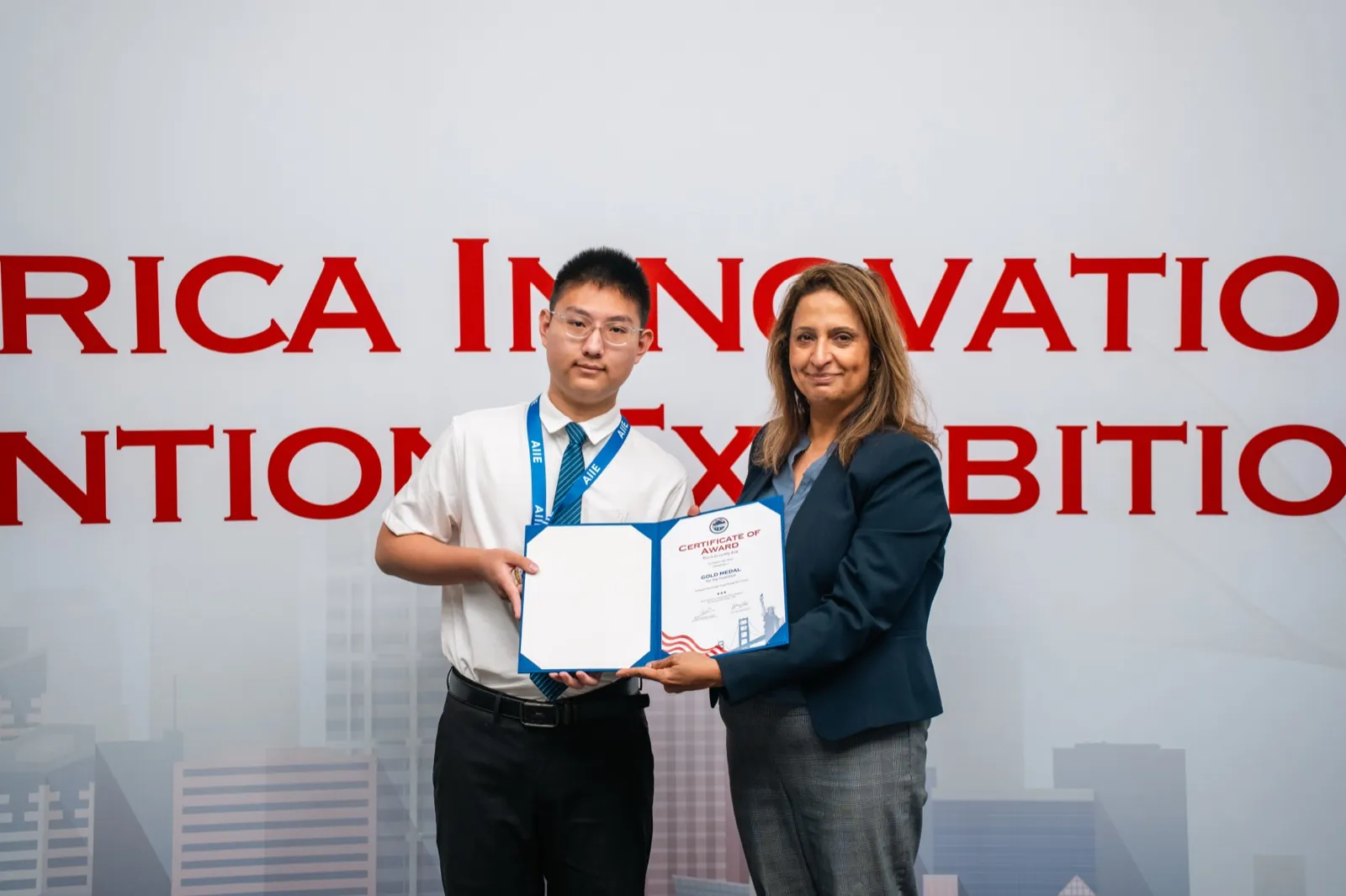 A gold medal certificate presented on stage at AIIE 2026